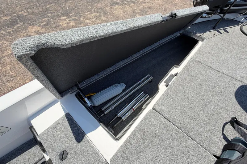 Slide: The Image of An open storage compartment on a boat with tools and accessories. - 17
