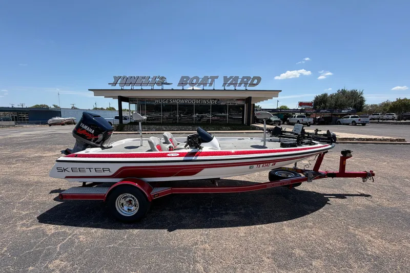Slide: The Image of 2008 Skeeter SX190 boat on trailer at Yowell's Boat Yard under clear blue sky. - 1