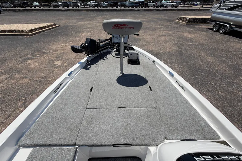 Slide: The Image of 2008 Skeeter SX190 boat deck with seating and motor, parked on asphalt. - 15