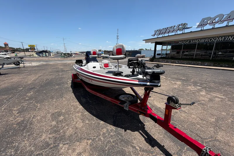 Slide: The Image of 2008 Skeeter SX190 boat on red trailer outside showroom under clear blue sky. - 50