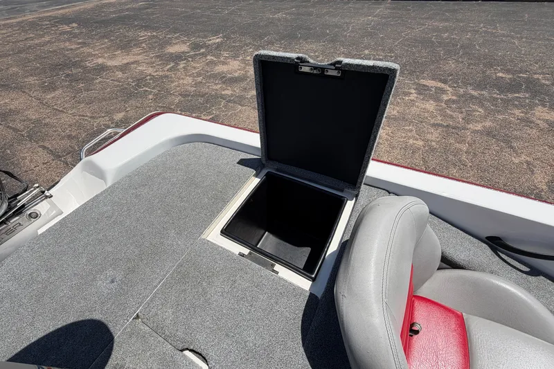 Slide: The Image of Open storage compartment on 2008 Skeeter SX190 boat with gray and red seating. - 39