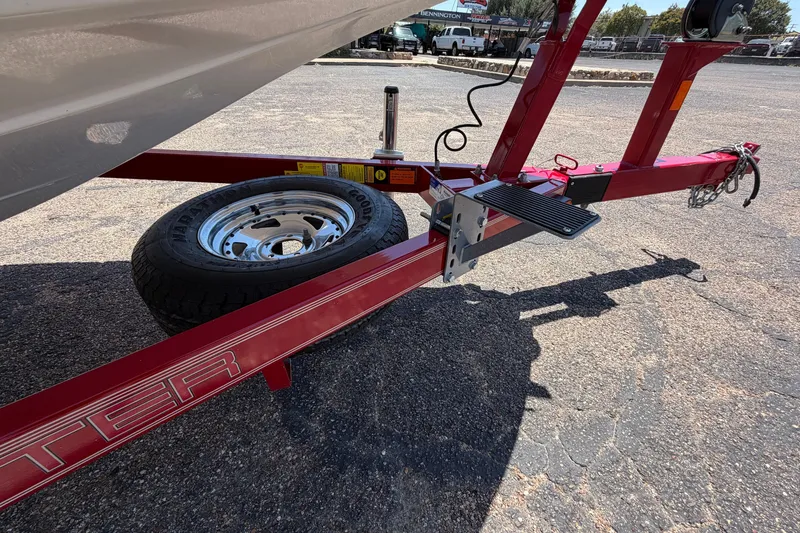 Slide: The Image of Red trailer for 2008 Skeeter SX190 boat with spare tire on asphalt. - 49