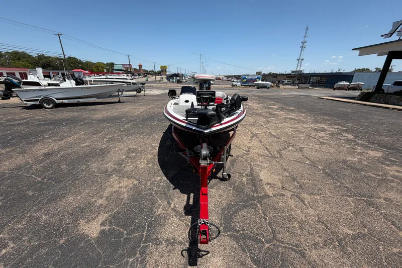 Slide: The Image of 2008 Skeeter SX190 boat on trailer in parking lot under clear sky. - 3