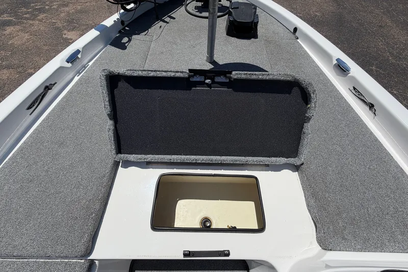 Slide: The Image of 2008 Skeeter SX190 boat interior with open storage compartment, gray carpeted deck. - 21