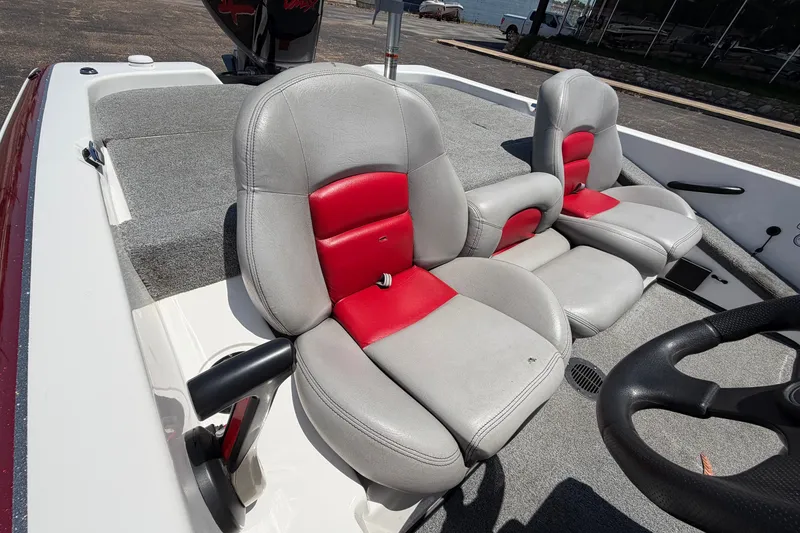 Slide: The Image of 2008 Skeeter SX190 boat interior with gray and red seats, steering wheel visible. - 32