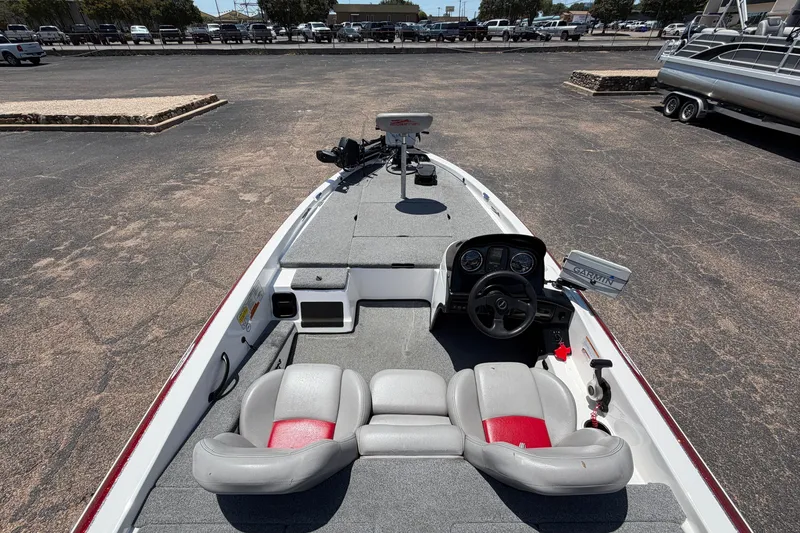 Slide: The Image of 2008 Skeeter SX190 boat interior with steering wheel and seating in a parking lot. - 10