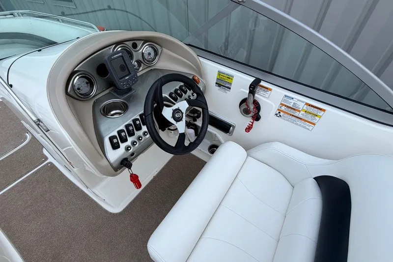 Slide: The Image of 2011 Hurricane SunDeck 237 OB boat cockpit with steering wheel and control panel. - 15