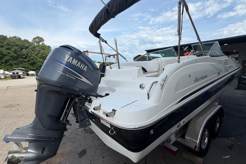 Slide: The Image of 2011 Hurricane SunDeck 237 OB boat with Yamaha four-stroke engine on trailer. - 4