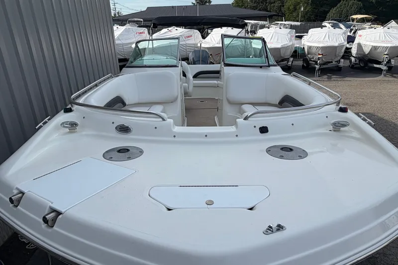 Slide: The Image of 2011 Hurricane SunDeck 237 OB boat with spacious seating, docked outdoors. - 6