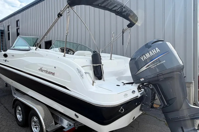 Slide: The Image of 2011 Hurricane SunDeck 237 OB boat with Yamaha outboard motor on trailer. - 3