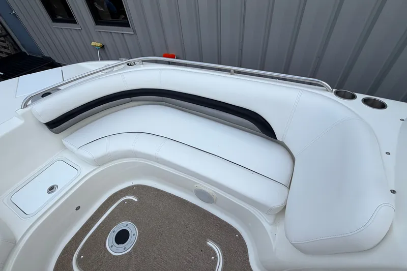 Slide: The Image of 2011 Hurricane SunDeck 237 OB boat interior with white seating and cup holders. - 18
