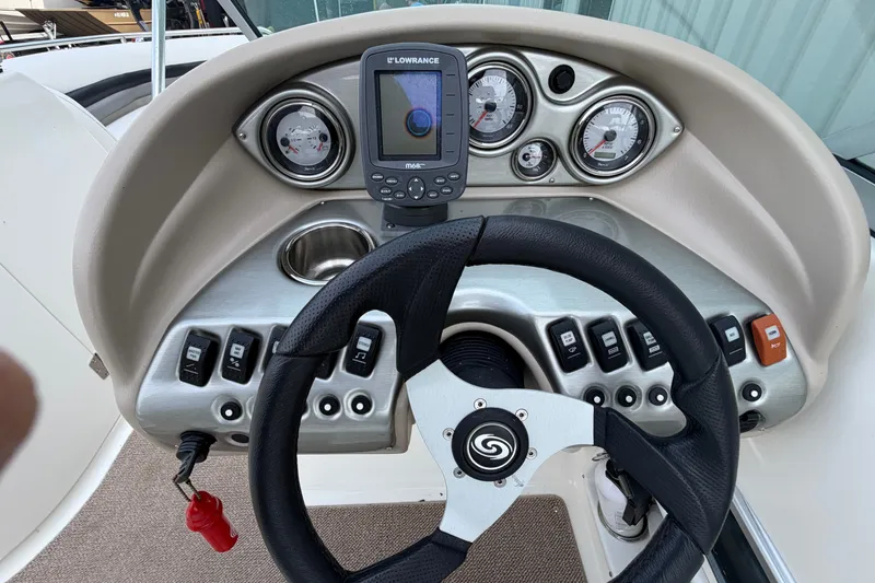 Slide: The Image of Steering console of 2011 Hurricane SunDeck 237 OB with gauges and controls. - 16