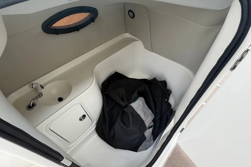 Slide: The Image of Interior of 2011 Hurricane SunDeck 237 OB boat with sink and storage area. - 10