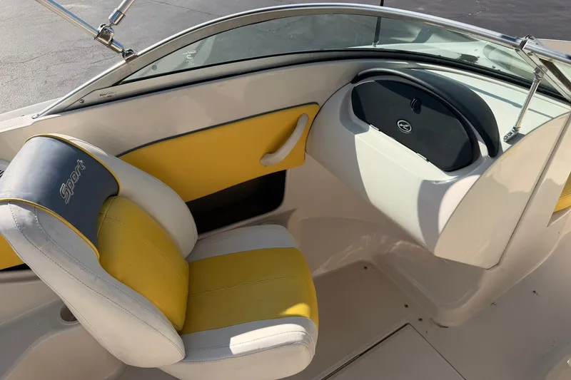 Slide: The Image of Interior of a 2006 Sea Ray 185 Sport boat with yellow and white seating. - 10