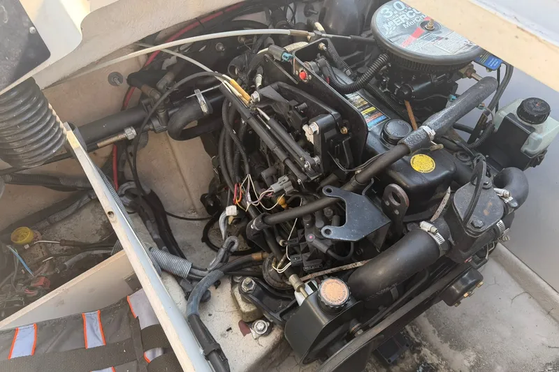 Slide: The Image of Engine compartment of a 2006 Sea Ray 185 Sport boat, showcasing mechanical components. - 13