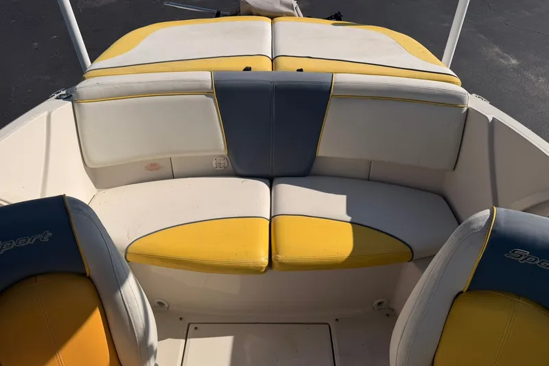 Slide: The Image of 2006 Sea Ray 185 Sport boat interior with yellow and white seating. - 8
