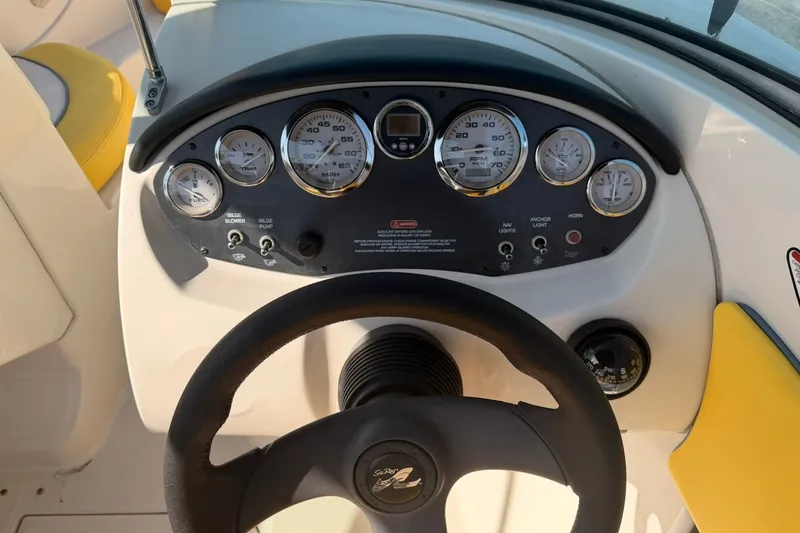 Slide: The Image of Dashboard of a 2006 Sea Ray 185 Sport boat with gauges and steering wheel. - 11