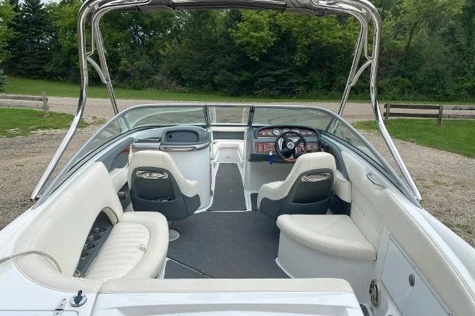Slide: The Image of Interior of a 2007 Cobalt 240 boat with white seating and sleek dashboard design. - 9