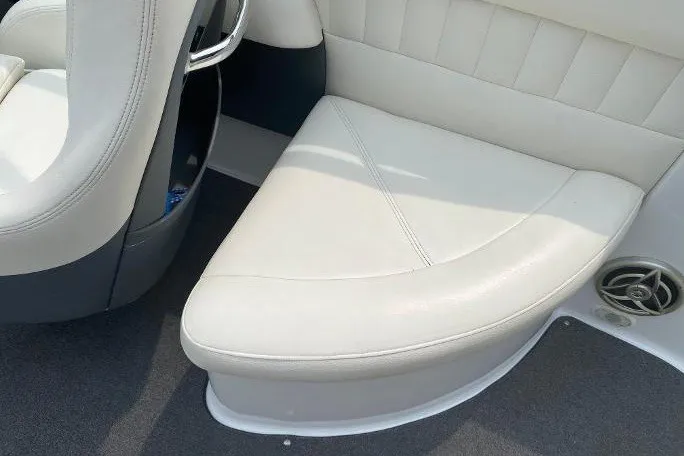 Slide: The Image of 2007 Cobalt 240 boat interior with white leather seating and speaker detail. - 10