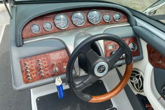 Slide: The Image of Dashboard of a 2007 Cobalt 240 boat with wood accents and gauges. - 6