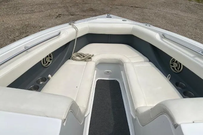 Slide: The Image of 2007 Cobalt 240 boat interior with white seating and cup holders. - 11