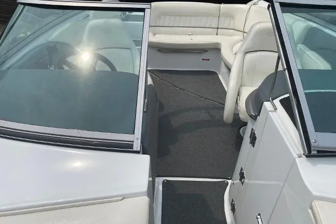 Slide: The Image of 2007 Cobalt 240 boat interior with white seating and steering wheel. - 12