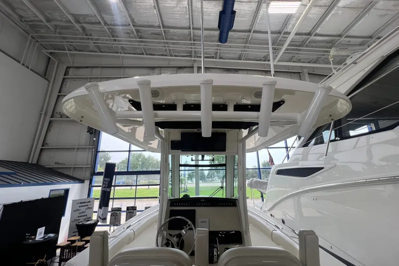 Slide: The Image of 2019 Boston Whaler 280 Outrage boat interior in showroom, showcasing helm and seating area. - 11