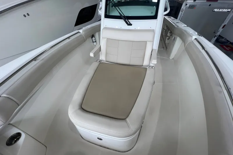 Slide: The Image of 2019 Boston Whaler 280 Outrage boat interior with cushioned seating and sleek design. - 18