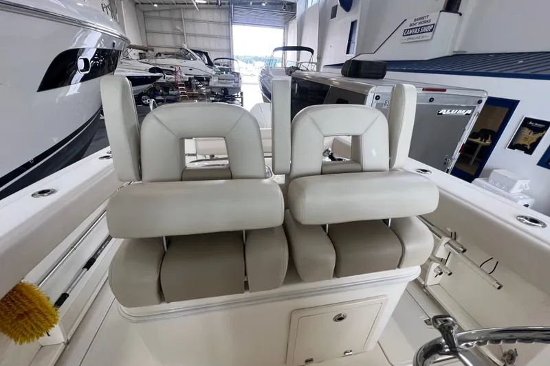 Slide: The Image of 2019 Boston Whaler 280 Outrage boat interior with dual cushioned seats in a showroom. - 8