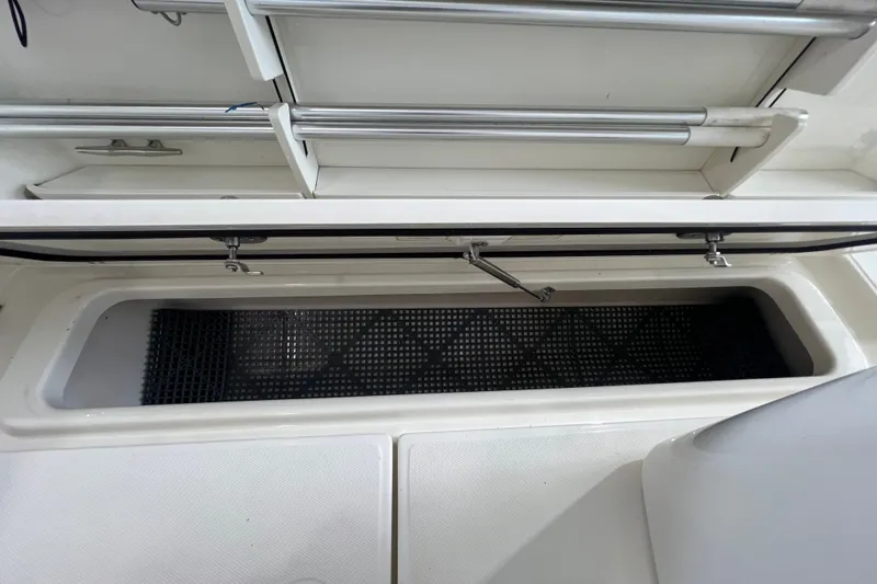 Slide: The Image of An open storage compartment on a 2019 Boston Whaler 280 Outrage boat. - 25