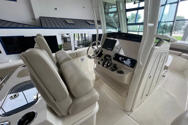 Slide: The Image of Interior view of 2019 Boston Whaler 280 Outrage boat cockpit with modern controls. - 10