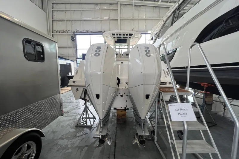 Slide: The Image of 2019 Boston Whaler 280 Outrage with twin engines in a showroom. - 2