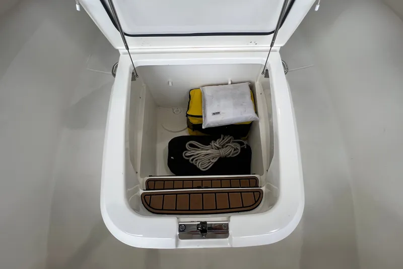 Slide: The Image of Storage compartment in 2019 Boston Whaler 280 Outrage with rope and bag. - 19