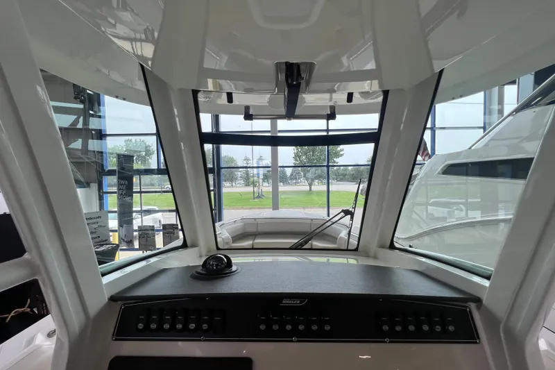 Slide: The Image of Interior view of 2019 Boston Whaler 280 Outrage boat cockpit with windshield and controls. - 15