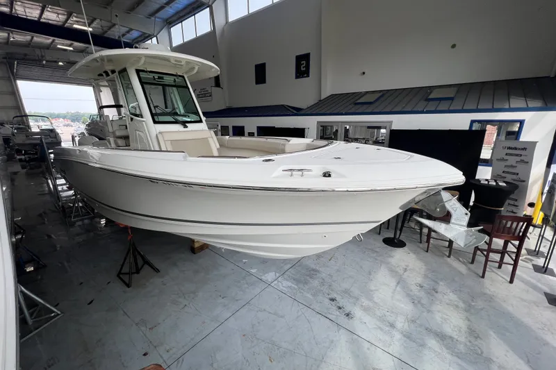Slide: The Image of 2019 Boston Whaler 280 Outrage boat displayed indoors on stands. - 1