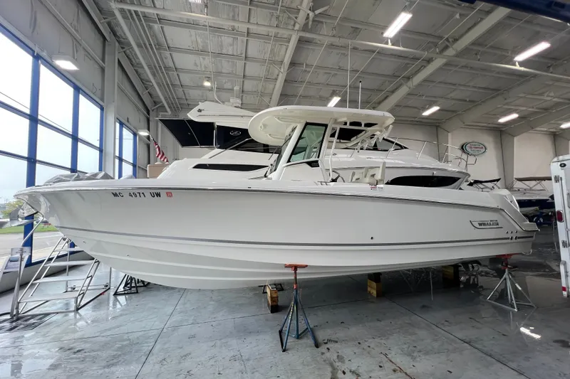 The Image of 2019 Boston Whaler 280 Outrage boat in indoor storage, side view. - 0