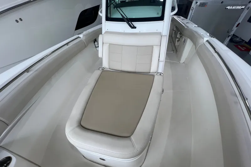 Slide: The Image of 2019 Boston Whaler 280 Outrage boat interior with cushioned seating area. - 17