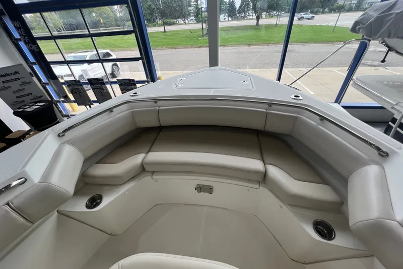 Slide: The Image of 2019 Boston Whaler 280 Outrage boat interior with cushioned seating and cup holders. - 20