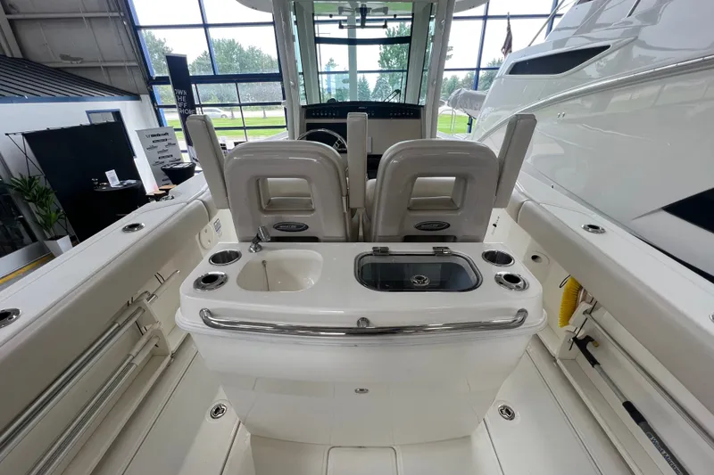 Slide: The Image of 2019 Boston Whaler 280 Outrage boat interior with seating and sink in showroom. - 6