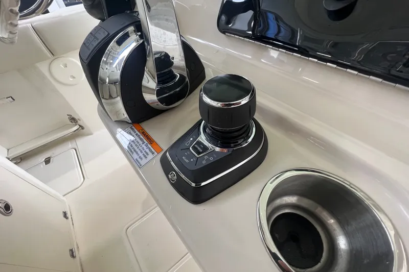Slide: The Image of Control panel of a 2019 Boston Whaler 280 Outrage boat, featuring joystick and throttle. - 13