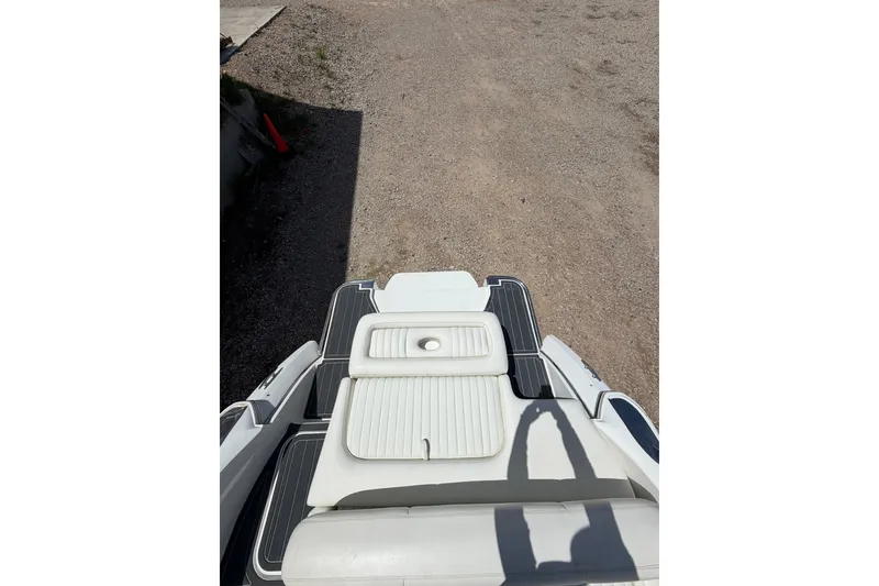 Slide: The Image of 2013 Cobalt R5 boat with white seating and deck, parked on gravel. - 11