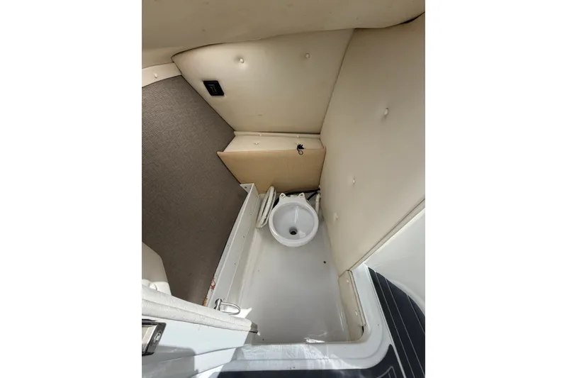 Slide: The Image of Interior of 2013 Cobalt R5 boat showing compact marine toilet area. - 13