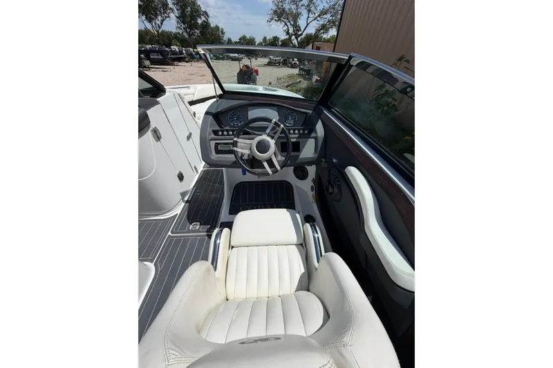 Slide: The Image of 2013 Cobalt R5 boat cockpit with steering wheel and white seating. - 5