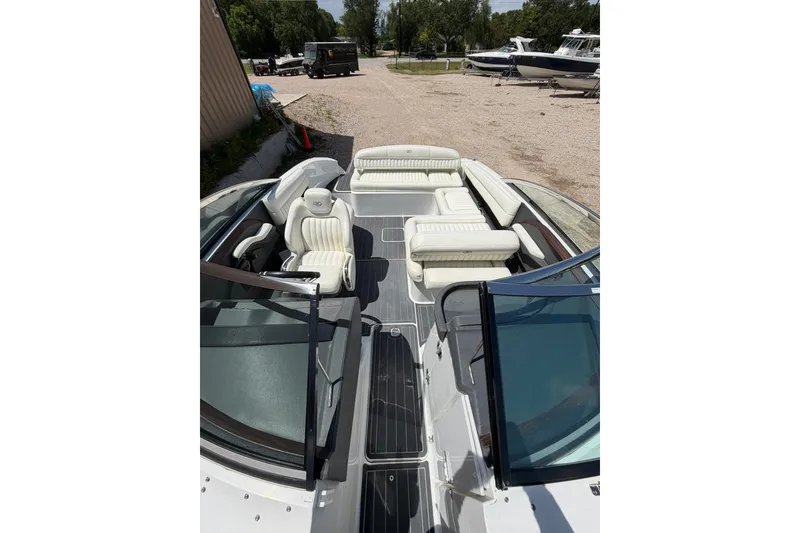 Slide: The Image of 2013 Cobalt R5 boat with white seating and open deck, parked outdoors. - 4