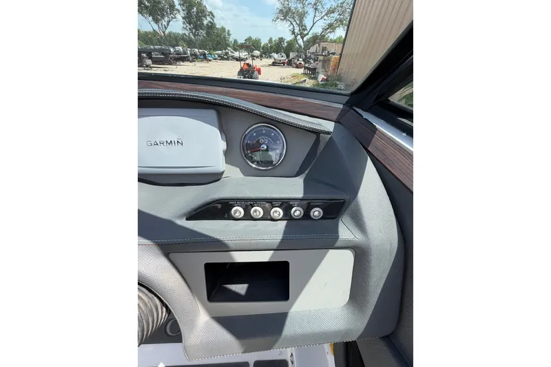 Slide: The Image of Dashboard of a 2013 Cobalt R5 boat featuring Garmin navigation and control switches. - 8
