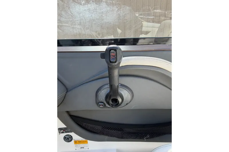 Slide: The Image of Throttle control lever on a 2013 Cobalt R5 boat dashboard. - 9