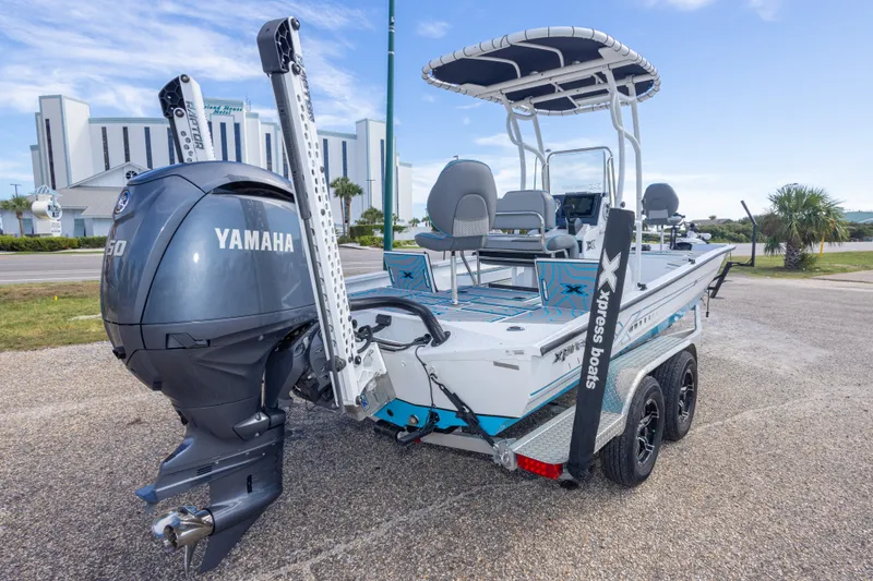 Slide: The Image of 2024 Xpress H22 Bay boat with Yamaha engine, parked on a trailer. - 15