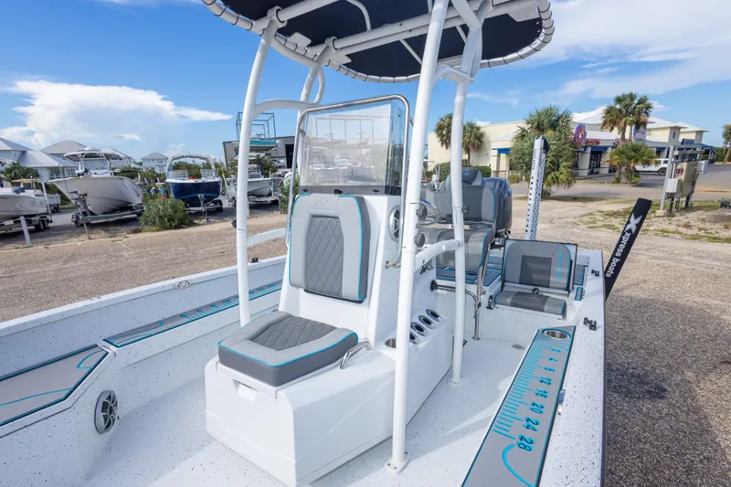 Slide: The Image of 2024 Xpress H22 Bay boat with modern seating and console, parked outdoors. - 37