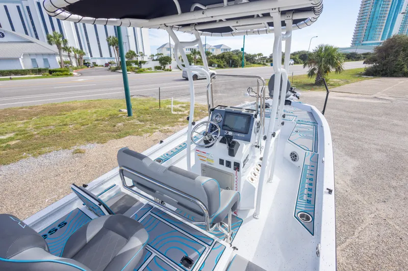 Slide: The Image of 2024 Xpress H22 Bay boat interior with modern dashboard and seating. - 22