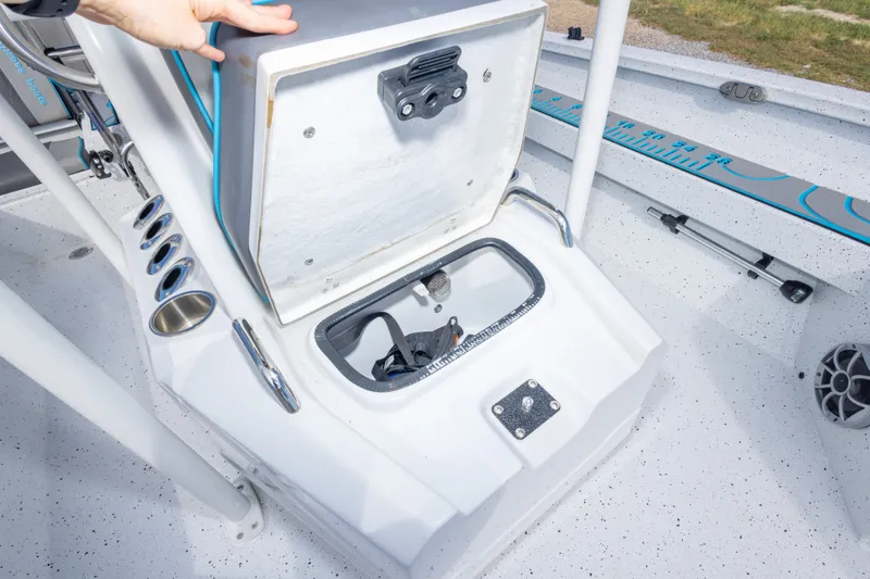 Slide: The Image of 2024 Xpress H22 Bay boat storage compartment with open lid and cup holders. - 38